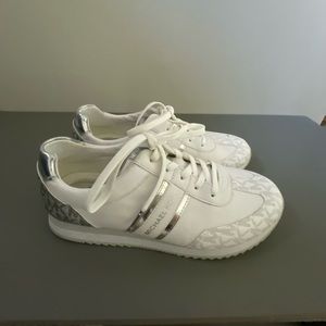 Michael Kors silver and white gym shoes.